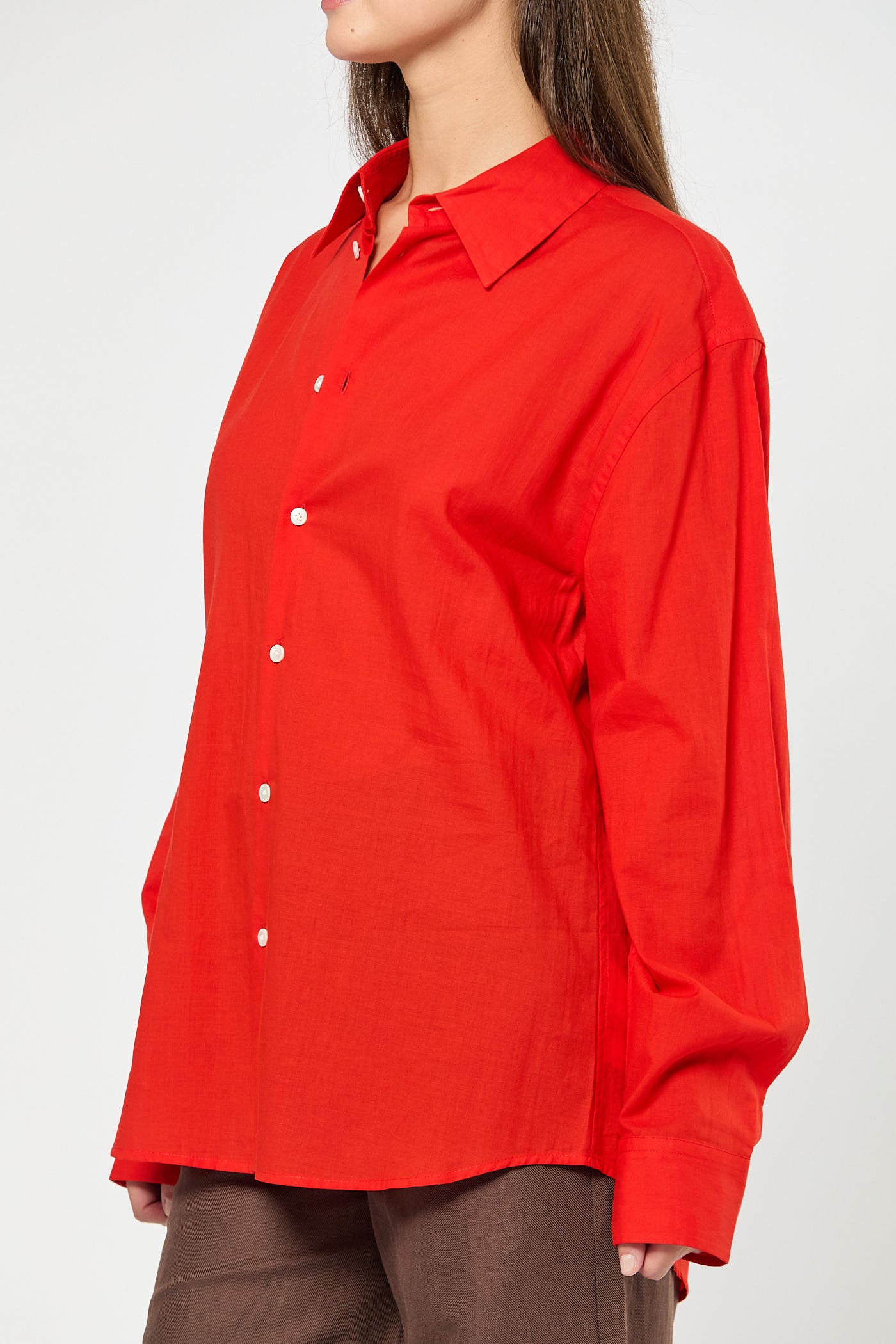 Red shirt worn by a person on a white background