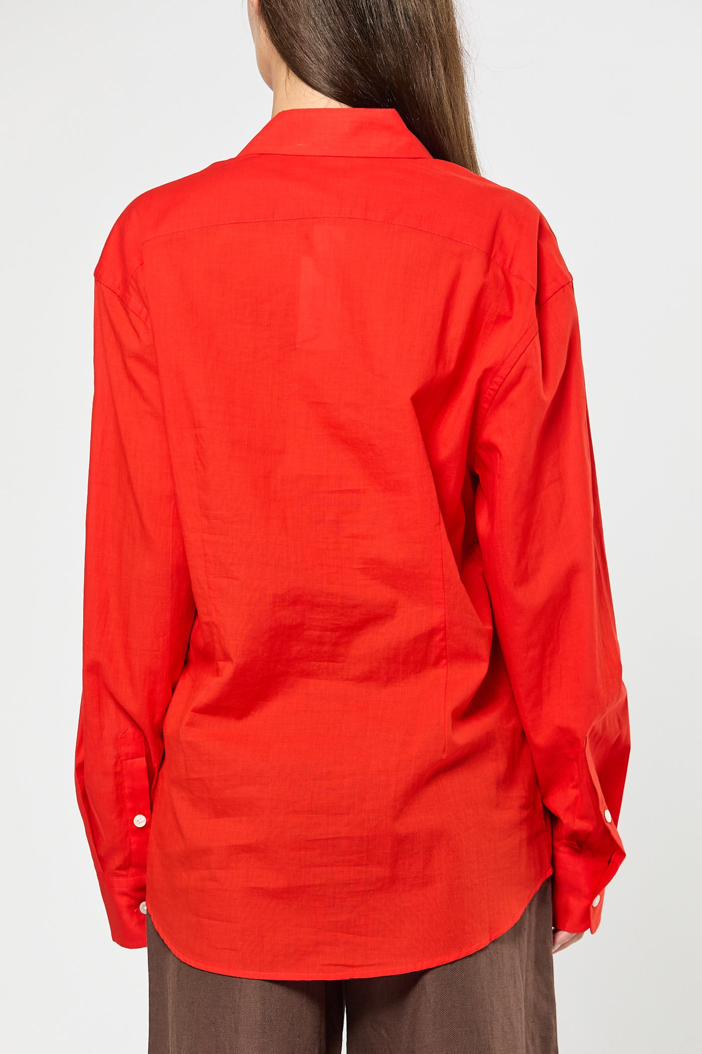Red shirt worn by a person on a white background