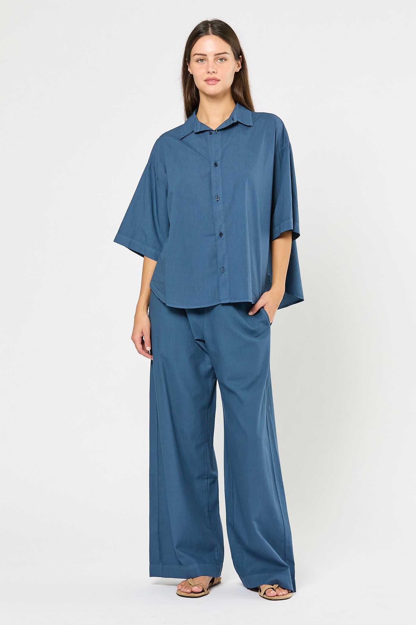 Woman wearing a blue outfit on a white background