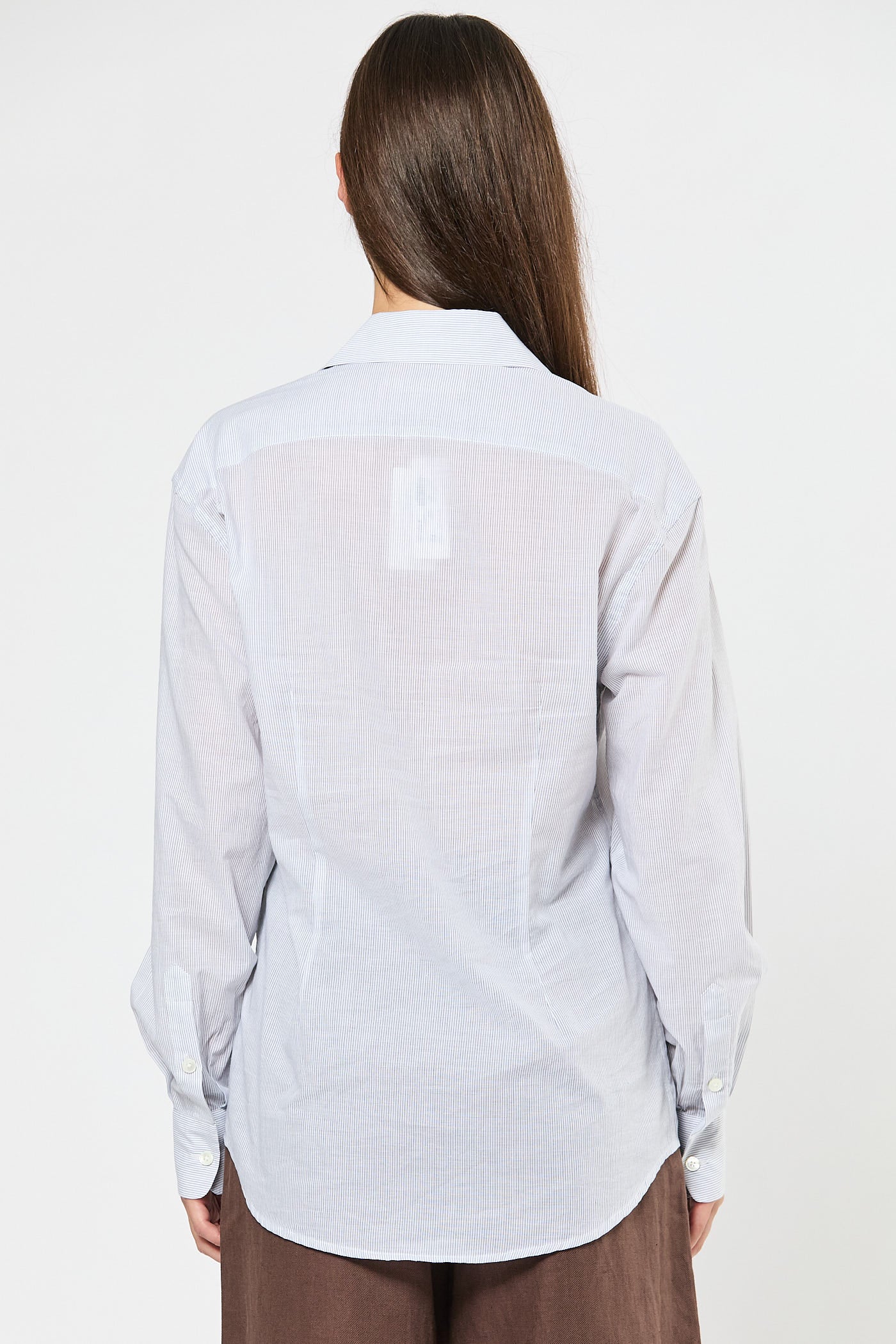 Person wearing a striped white shirt on a white background