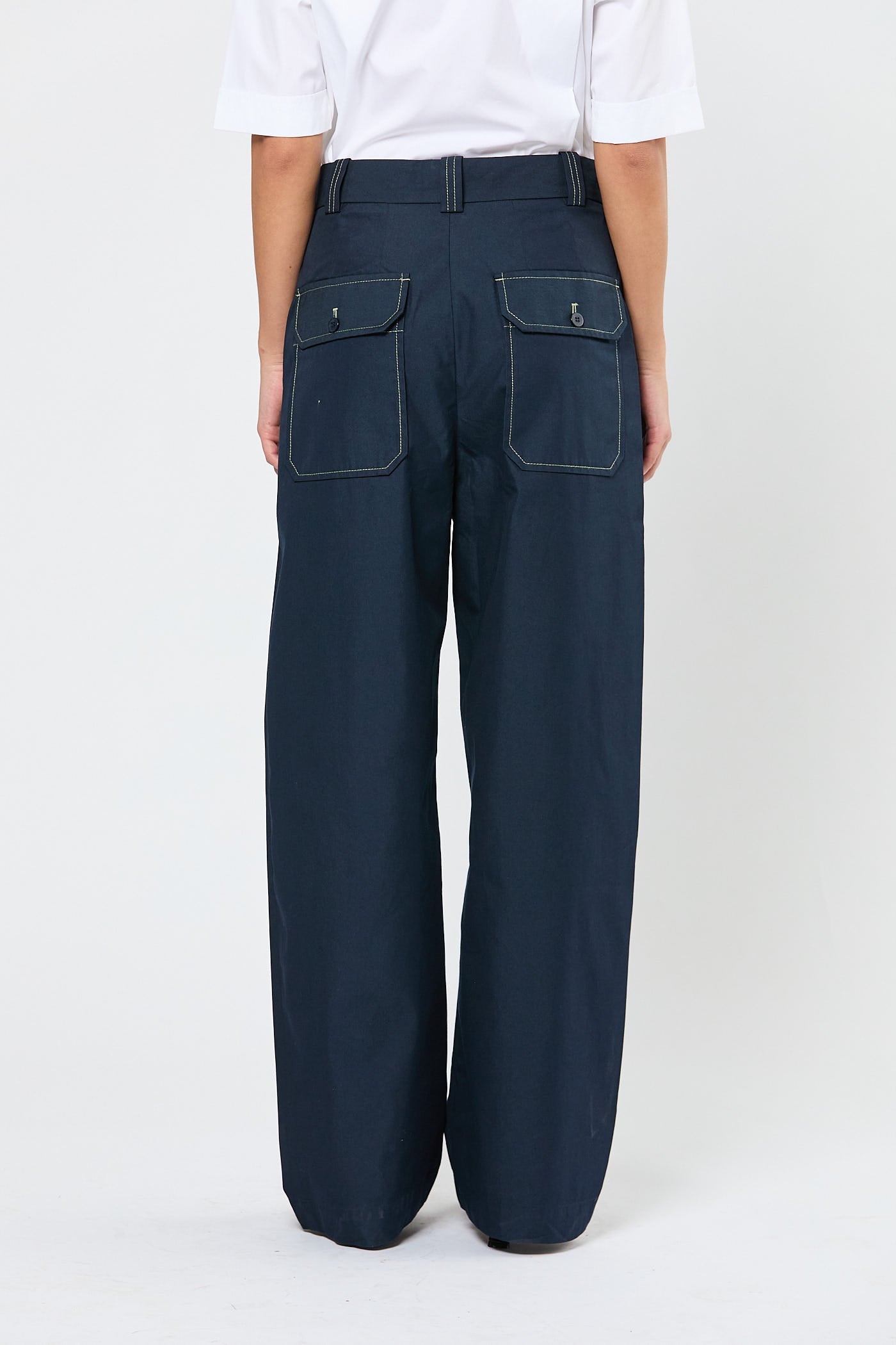 Navy blue pants worn by a person on a white background