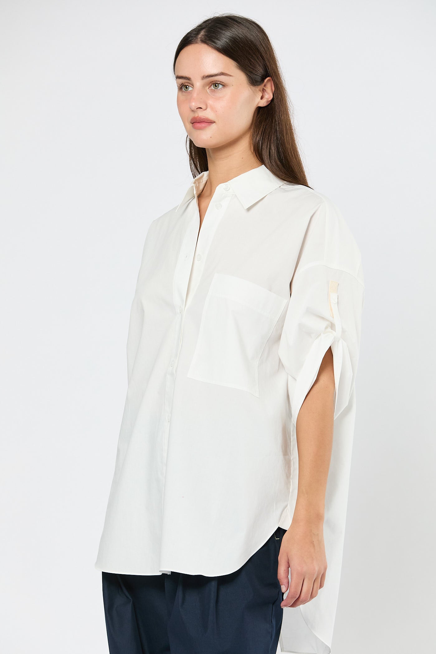 Woman wearing a white blouse with a plain background