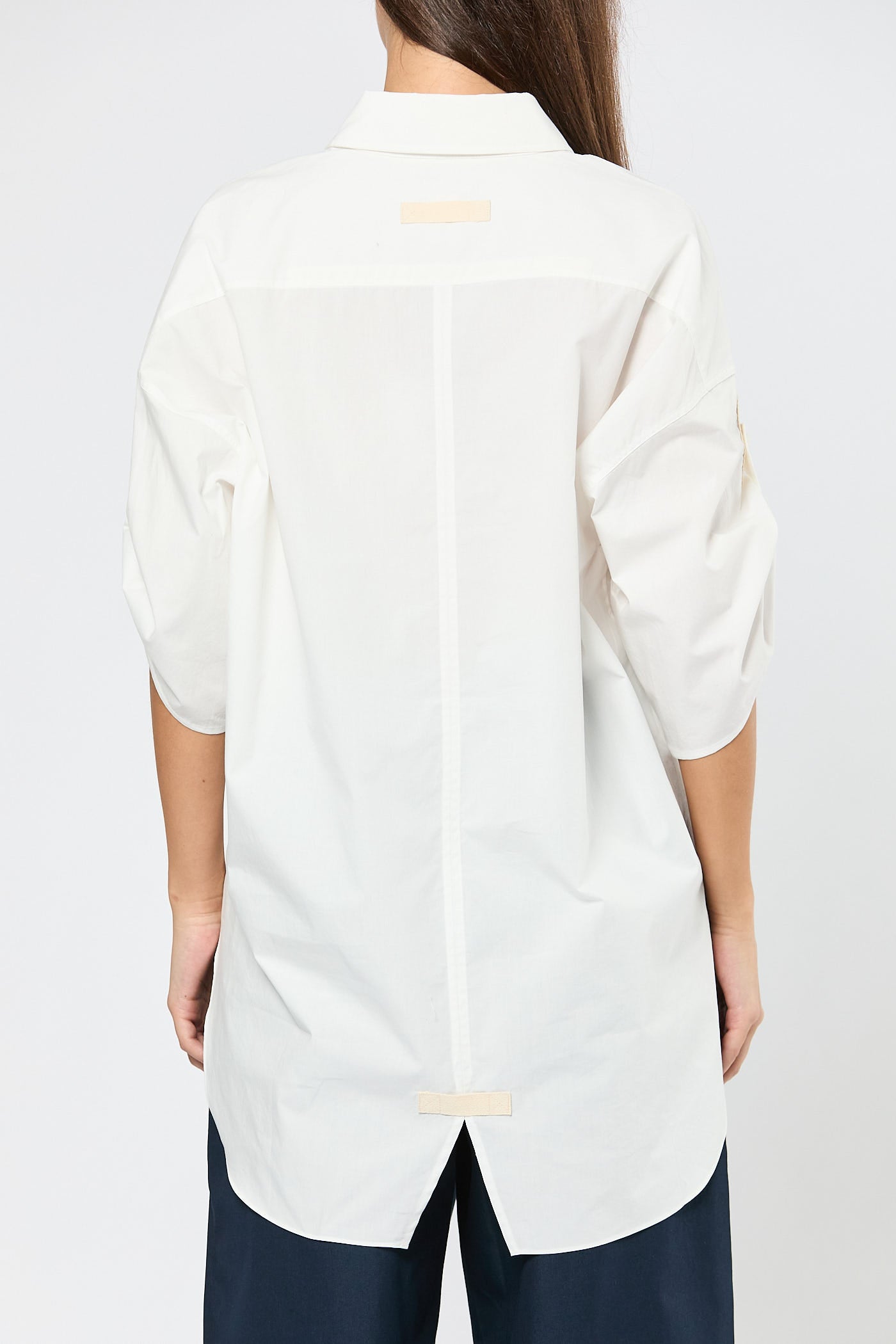 White shirt worn by a person on a plain background