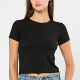 Woman wearing a black t-shirt and blue jeans on a white background