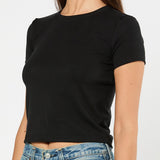 Person wearing a black t-shirt and blue jeans on a white background