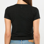 Person wearing a black t-shirt and blue jeans on a white background